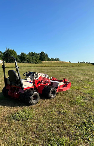 Red mower in a field